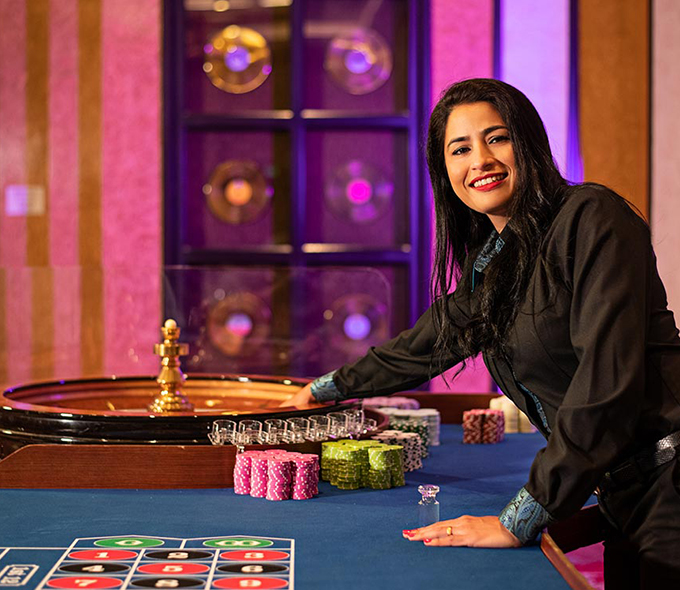 Woman spinning the wheel for Roulette at the Casino